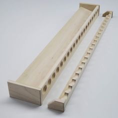 two wooden pegs with holes in them sitting next to each other on a white surface