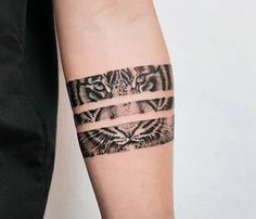 a tattoo on the arm of a person with a tiger and bird design in it