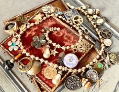 A richly curious, and loaded vintage assemblage necklace, this lovely piece is the result of culling a great number of vintage pieces including earrings, buttons, charms, and antique collectibles.  Most of the components have underlying dark or brass tones, making it a rich collection closely gathered to be a feast for the eye.  Some notable items of interest: - an 1800's tintype that I set in a bezel - a luminescent glass antique button - a watchmakers key - a lovely large round gold earring drop with rhinestones - a ladies vintage watch case in which I placed an antique black glass diminutive button - a cream colored etched celluloid button with filigree trim...early 1900's - an add-on striped bar to a military pin I work with antique and vintage parts. Some may show signs of wear or age Vintage Brass Necklaces With Cabochon, Vintage Assemblage Jewelry Silver, Antique Beads, Gems, And Cabochons As Gifts, Military Pins, Vintage Assemblage Necklace, Handmade Vintage Agate Beads, Gems, And Cabochons, Statement Choker, Vintage Assemblage, Vintage Amber Polished Beads, Gems, And Cabochons