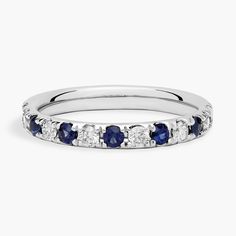 a white gold ring with blue and white diamonds