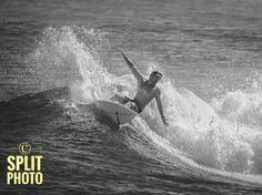 a man riding a wave on top of a surfboard