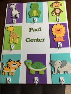 a sign with different animal magnets on it that says pacci center in front of them