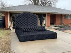 a bed sitting in the middle of a driveway