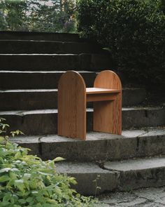 a wooden bench sitting on top of stone steps