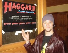 a man standing in front of a sign that says haggard