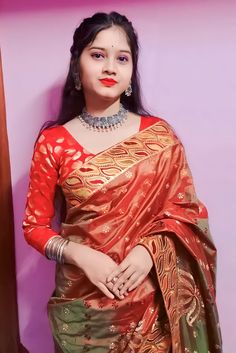 a woman in a red and green sari