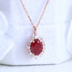 This timelessly elegant oval ruby necklace is set in the lustrous 14k gold tiara halo diamond drop pendant featuring an oval-shaped vivid red ruby surrounded by brilliant white diamonds that dangle beautifully from a solid gold cable chain. The length of the gold chain can be adjusted to either 16" or 18" long to suit your style! This ruby and diamond necklace can be crafted in your choice of white, rose, or yellow gold. ** The listing price is for one necklace only Availability: Ready to Ship: Elegant Ruby Jewelry With Halo Setting, Formal Ruby Necklace With Halo Setting, Dazzling Red Jewelry With Halo Design, Fine Ruby Jewelry With Oval Pendant, Fine Jewelry Ruby Oval Pendant, Elegant Ruby Halo Jewelry, Fine Jewelry Wedding Necklace With Lab-created Ruby, Wedding Fine Jewelry Necklace With Lab-created Ruby, Fine Jewelry Lab-created Ruby Necklaces For Wedding