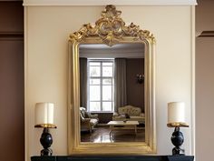 a living room with a large mirror on the wall