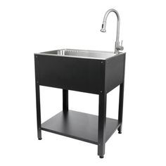 a black sink with a faucet on the side and an open shelf underneath it