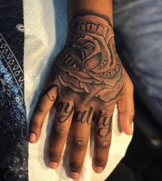 a person's hand with a tattoo on it and the word beauty written in cursive writing