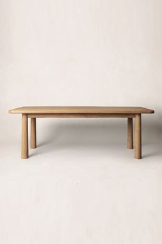 a wooden table sitting on top of a white floor