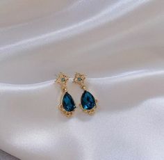 Our beautiful Gold & Blue drop earrings would make beautiful wedding or prom earrings The drop is 2.5cm The width and length of the blue gem is 1cm Check out our mix and match any 4 items of your choice for £30!  In every listing there is a mix and match photo with a number unique to that item, when purchasing the mix and match listing please quote the 4 unique item numbers so I know which items you would like sending.  If the listing has different colours or styles please also specify this with Water Earrings, Nails Elegant, Earrings Prom, Dainty Gold Earrings, Blue Drop Earrings, Dangle Earrings Gold, Drop Earrings Gold, Prom Earrings, Deep Winter