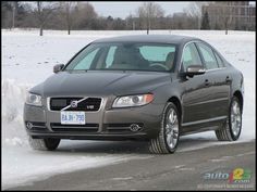 a volvo car is driving down the road in the snow