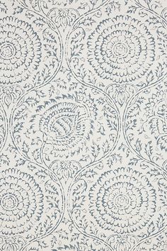 a white and blue wallpaper with an intricate design