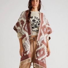 Effortlessly Cool And Oh-So Comfy, This Detailed Poncho Is Featured In An Oversized Style With A Chic Geometric Print. Fit: Relaxed And Oversized Features: Open-Front Design, Split Sides, Relaxed Sleeves, Cozy Woven Fabrication, Geometric Print, Tassel Trim Why We <3 It: The Perfect Layering Piece, Throw This On Over Long Sleeve Tees And Sweatshirts To Keep You Warm While Embracing Your Personal Style. Care + Content Machine Wash Cold Import 87% Cotton, 13% Polyester Free People Jean Jacket, Brown Fringe, Blanket Poncho, Free People Jacket, Santa Fe Nm, Oversized Style, Embroidered Jacket, Shrug Sweater, Free People Sweater