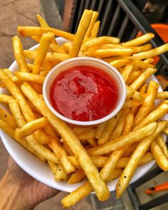 a white plate topped with french fries and ketchup