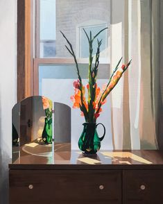 a vase filled with flowers sitting on top of a wooden table next to a mirror