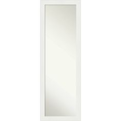 a white door with a mirror on the front and bottom panel, in an empty room