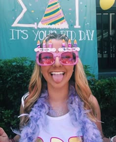 a woman wearing sunglasses and a birthday hat