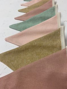 five different colors of fabric lined up on a table