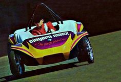 a man riding on the back of a yellow and white car