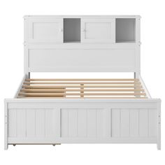 a white bed frame with wooden slats and drawers on top of the headboard