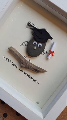 a paper cut out of a bird wearing a graduation cap