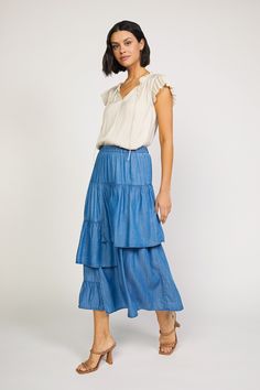 This chambray asymmetrical tiered midi skirt features an elastic waistband for a comfortable and adjustable fit. Its quality construction and fabric provides maximum durability, perfect for everyday wear. The varied length tiers create a flattering silhouette for any body shape. •Relaxed fit •A Line Cut •Tiered Detail Nashville Outfits Summer, Tiered Midi Skirt, Nashville Outfits, A Line Cut, Water Usage, Print Trends, Sweater Sale, Trending Dresses, Body Shape