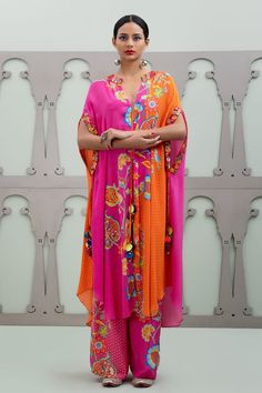 Multicolour asymmetric kurta with floral patterns on an ombre base and placement sequin embroidery. Comes with pant.
Components: 2
Pattern: Embroidered
Type Of Work: Floral, Sequin
Neckline: Mandarin Collar
Sleeve Type: Cape Sleeves
Fabric: Crepe
Color: Multi Color
Other Details: 
Model Height: 5ft 10inches wearing size S
Weight: 800 grms
Occasion: Sangeet,Mehendi and Haldi - Aza Fashions Asymmetric Kurta, Pant For Women, Sequin Embroidery, Cape Sleeves, Kurta With Pants, Sequins Embroidery, Floral Patterns, Mandarin Collar, Aza Fashion