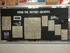 a bulletin board with several historical articles on it