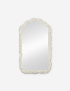 a white mirror with an ornate frame