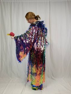 This sparkling maxi length kimono robe with bell sleeves is sure to make you stand out in the crowd. The iridescent holographic color shifting sequins catch sunlight and reflect a rainbow of colors all around you. These sleeves are incredible and like no other sequin kimono out there. It looks great on stage and is very demanding of attention. All eyes on you! It wears great from day to night, is unlined, and has a mesh foundation so it does not get too hot while you are dancing your heart out a Spring Party Robe With Kimono Sleeves, Multicolor Long Sleeve Kimono For Party, Multicolor Long Sleeve Party Kimono, Long Multicolor Party Kimono, Luxury Multicolor Kimono For Festivals, Multicolor Kimono-sleeved Cover-up For Festivals, Festive Multicolor Silk Kimono, Tie-dye Kimono With Kimono Sleeves For Festivals, Festival Tie-dye Kimono With Kimono Sleeves