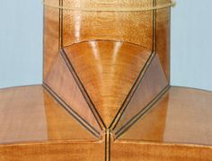 a close up view of the back of a wooden chair with stitching on it