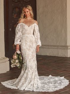 Introducing the Aspen Dress—your one-of-a-kind wedding gown brought to life. This off-the-shoulder wedding dress with sleeves is designed to make you feel like the most unique and beautiful bride. Crafted from luxurious textured cord cotton lace, it combines comfort with elegance. The off-the-shoulder neckline and dipped lower back create a stunning silhouette, while the voluminous puffed sleeves add a touch of romance.

The trumpet-fitted silhouette features a princess seaming down the front an Wedding Dresses Off The Shoulder Sleeves Boho, Boho Wedding Dress Off The Shoulder, Lace Off The Shoulder Wedding Dress, Off The Shoulder Wedding Dress, Wedding Dress With Sleeves, Shoulder Wedding Dress, Long Sleeve Wedding Dress Lace, Dress With Sleeves, Wedding Dreams