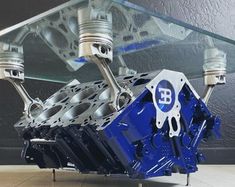 a blue engine is sitting under a glass table