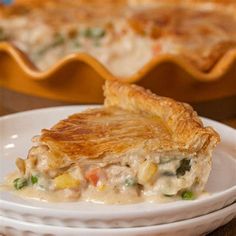 a white plate topped with a piece of pie next to a casserole dish