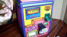 someone is playing with an old school arcade machine that looks like it's made out of cardboard