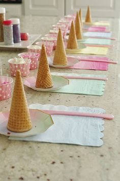 there are many cones on the table for desserts to be made out of paper