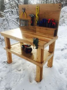 a work bench with tools on it in the snow