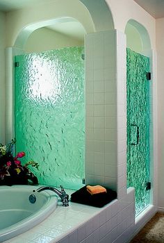 a bath room with a large tub and a mirror on the wall next to it