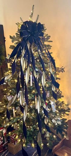 a christmas tree decorated with ribbons and lights