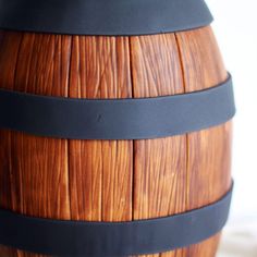 a wooden barrel with black straps on it