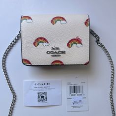 Authentic Brand New With Tags In Original Packaging Including Coach Shipping Plastic And All Protective Materials Limited Edition Pride Collection Coach Mini Wallet On A Chain With Rainbow Print Silver/Chalk Multi Printed Coated Canvas And Smooth Leather Style No. Ck391 Two Credit Card Slots Snap Closure, Fabric Lining Outside Open Pocket Detachable Chain Strap With 23 1/4" Drop For Shoulder Or Crossbody Wear 4" (L) X 3" (H) X 1" (W) Chic White Wallet On Chain For Everyday, Trendy White Wallets For Gifts, Trendy White Rectangular Wallet, Coach White Rectangular Wallet, White Coach Wallet For Gift, Coach Cream Bag As Gift, Coach Cream Bag Perfect For Gifts, Coach Cream Bag For Gift, Cream Coach Bag As Gift