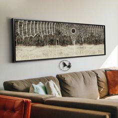 a living room with couches and paintings on the wall