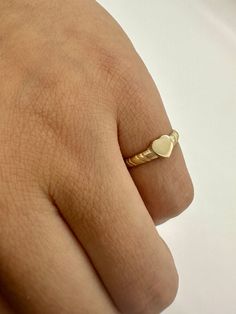 Here we have a 14k Heart Signet Ring for a lady's pinky or perfect for a young girl. This is an adorable heart ring with a lot of charm. Made of solid 14k gold it can be worn daily and everywhere without worries.   Ring is shown on woman's pinky finger size 2 1/2  **Petite ring**  If interested in engraving please checkout with the following add-on: https://www.etsy.com/listing/1260011718/ -------------------------------------- Visit us on Instagram @agoldmindjewelry for our custom jewelry designs and newest listings ▬ All jewelry pieces are sent in a gift box  ▬ Our shipping and return policies: ~ Items will be shipped Free via USPS Ground Advantage. We gladly accept returns, exchanges, and cancellations ~ Contact us within: 3 days of delivery ~ Ship items back within: 7 days of delivery Small Heart Ring, Gold Heart Ring For Valentine's Day, Cute Gold Heart Ring For Valentine's Day, Cute Gold Rings For Valentine's Day, Cute Heart Ring For Valentine's Day Anniversary, Dainty Stackable Heart Ring For Valentine's Day, Cute Gold Heart Promise Ring, Cute Rings For Anniversary On Valentine's Day, Dainty Valentine's Day Stackable Heart Ring