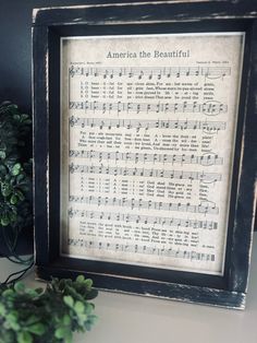 an old sheet music is framed in a black frame with the words america the beautiful