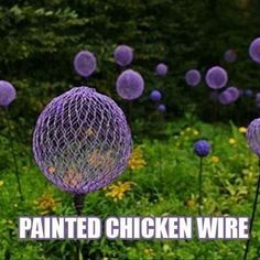 purple flowers with the words painted chicken wire on them in front of green grass and trees