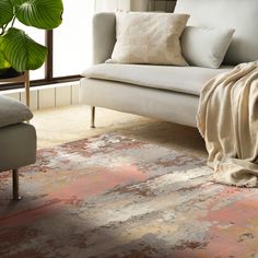 a living room with a couch, chair and rug