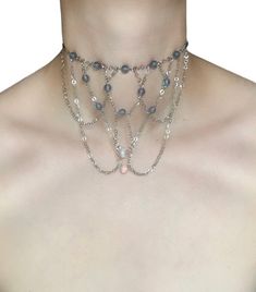 Grey Aura Choker 🤍 This choker is made with draped silver chains and grey aura beads, creating a look that is both ethereal and edge Only one available as I like to make one of a kind pieces so that you have a unique, standout, rare, special piece that you can't find anywhere else. Care Instructions: Keep your jewellery away from water, oils, perfumes and make sure to remove before showering and sleeping in order to keep it in it's best condition. All intellectual property rights in our designs are and will belong to Sphider Ltd Any infringement will be pursued vigorously. Sphider Design Unique, Quirky, Alternative, Grunge, Alt, EGirl, Boho, Fairygrunge, Grungegirl, Handmade Alternative Necklace, Grey Aura, Alt Egirl, Alternative Grunge, Diy Jewelry Projects, Property Rights, Beach Boho, Silver Choker, Silver Chains