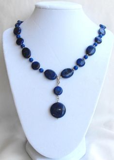 Beautifully designed natural blue Lapis Lazuli dangle pendant beaded necklace. One of a kind. Blue Beaded Necklaces With Natural Stones, Gift Blue Drop Necklace With Natural Stones, Blue Beaded Dangle Necklaces With Natural Stones, Blue Dangle Necklaces With Gemstone Beads, Blue Beaded Necklaces With Natural Stones And Dangle Shape, Blue Dangle Necklaces With Polished Beads, Blue Gemstone Beads Dangle Necklaces, Blue Dangle Gemstone Beads Necklace, Blue Pendant Beaded Necklace With Single Strand